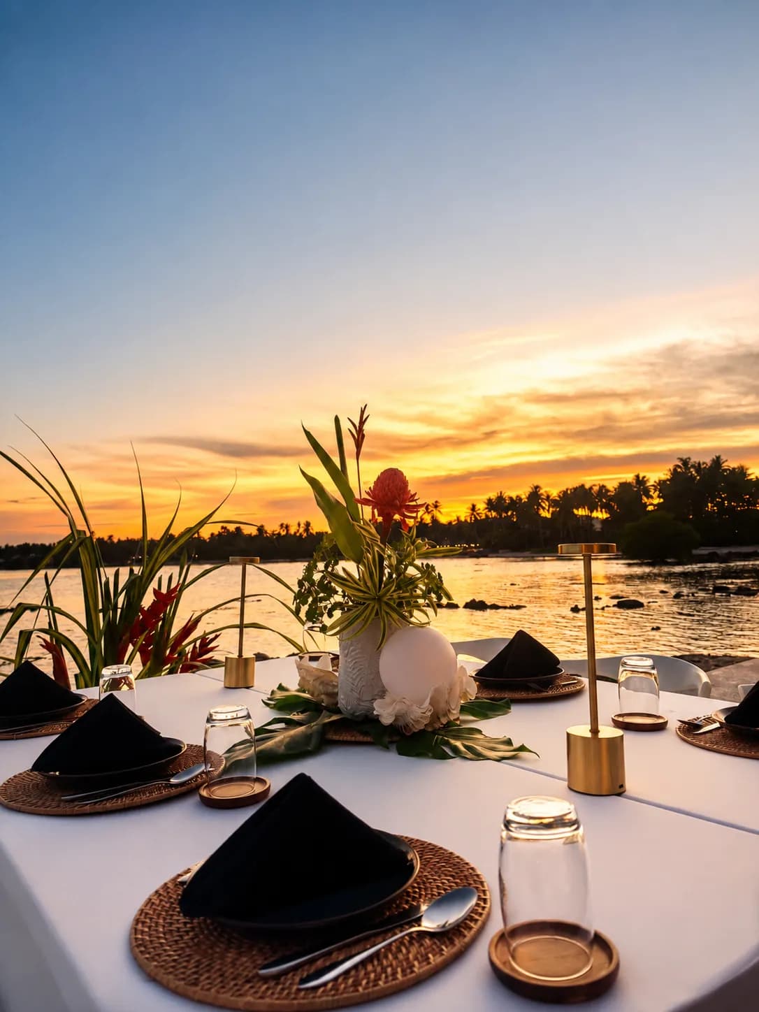An elegant open-air tropical restaurant prepared for dining