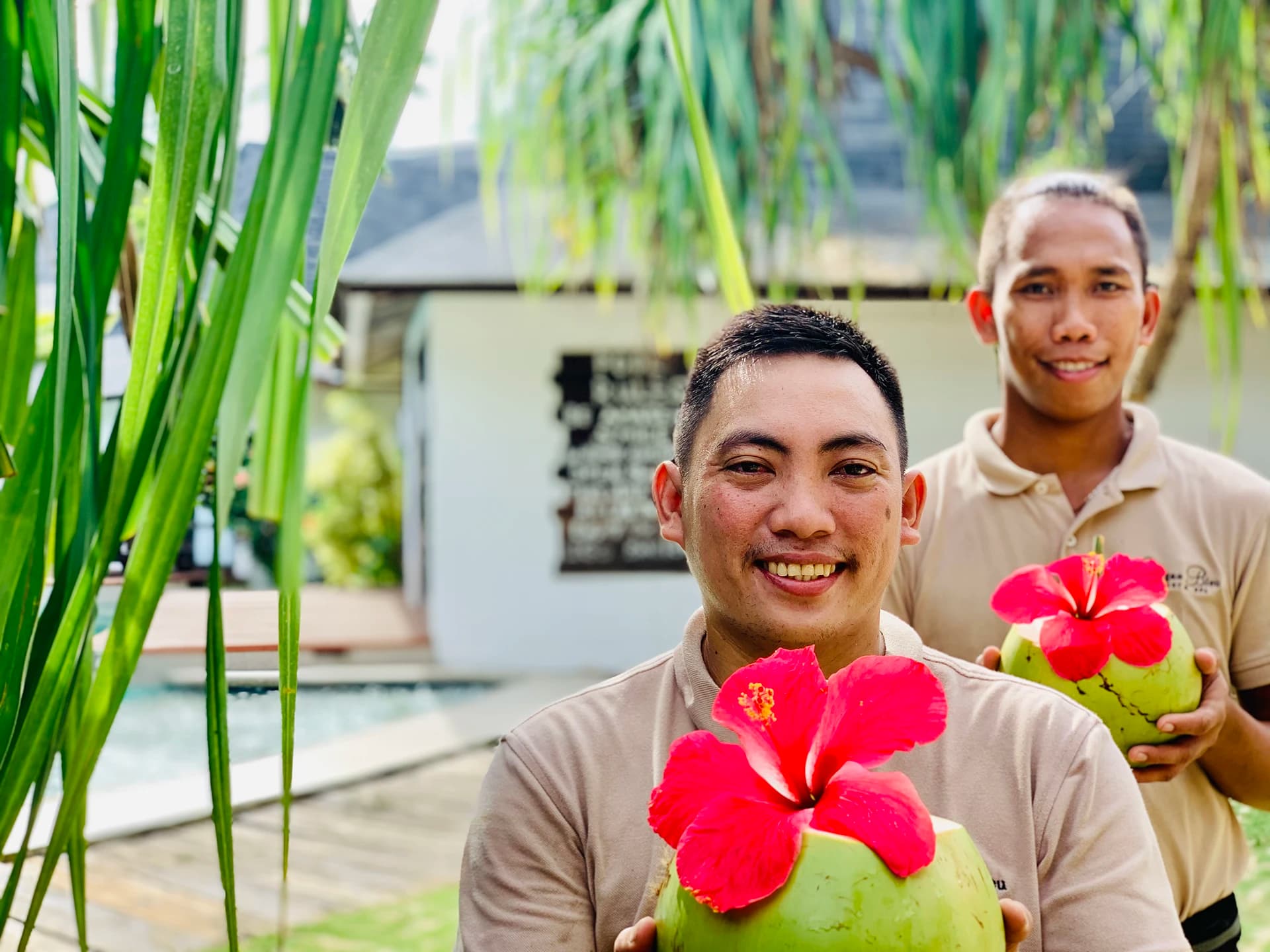 Siargao Bleu team members welcoming guests with fresh coconuts